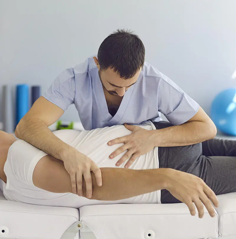 ACG - chiropractor therapist working with male patient