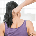 ACG-Chiropractor adjusting neck muscles to female