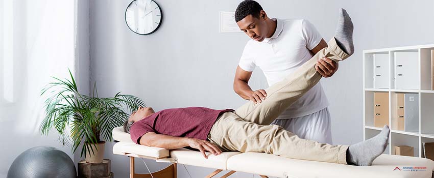 American chiropractor working with middle aged man