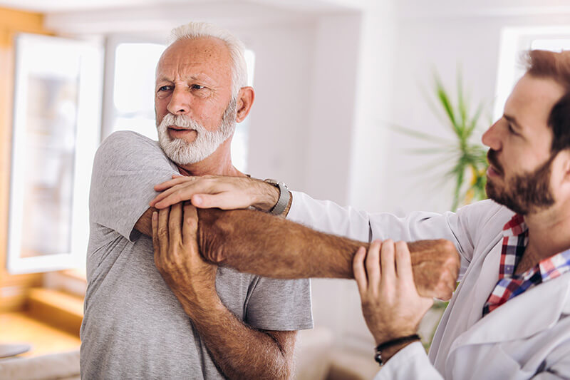 ACG Senior man exercises in center for chiropractic